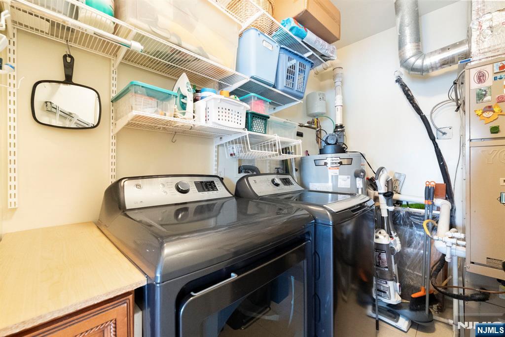 108 The Promenade, Unit 108 Edgewater, NJ 07020 - Photo 39 of 49 a utility room with multiple dryer and washer