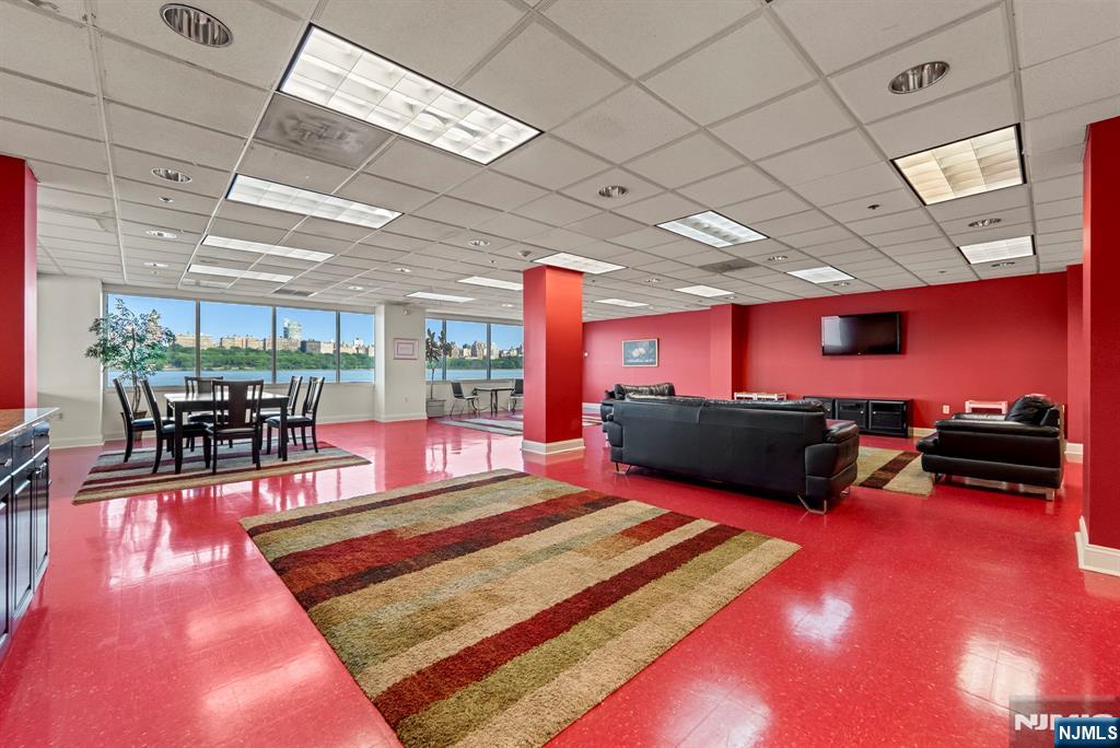 108 The Promenade, Unit 108 Edgewater, NJ 07020 - Photo 43 of 49 a living room with furniture flat screen tv and a table