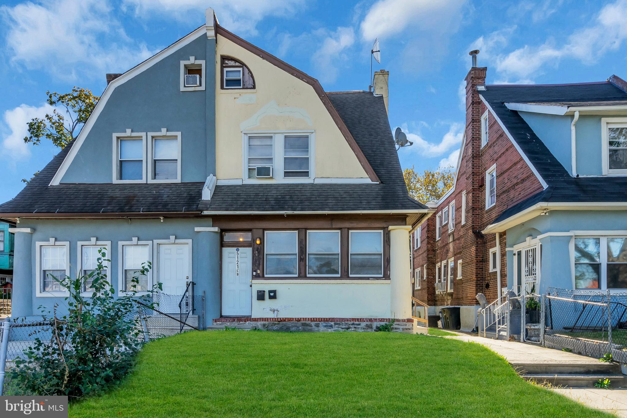5121 East Roosevelt Boulevard, Unit 2 Philadelphia, PA 19124 - Photo 1 of 23 a front view of a house with a yard and porch