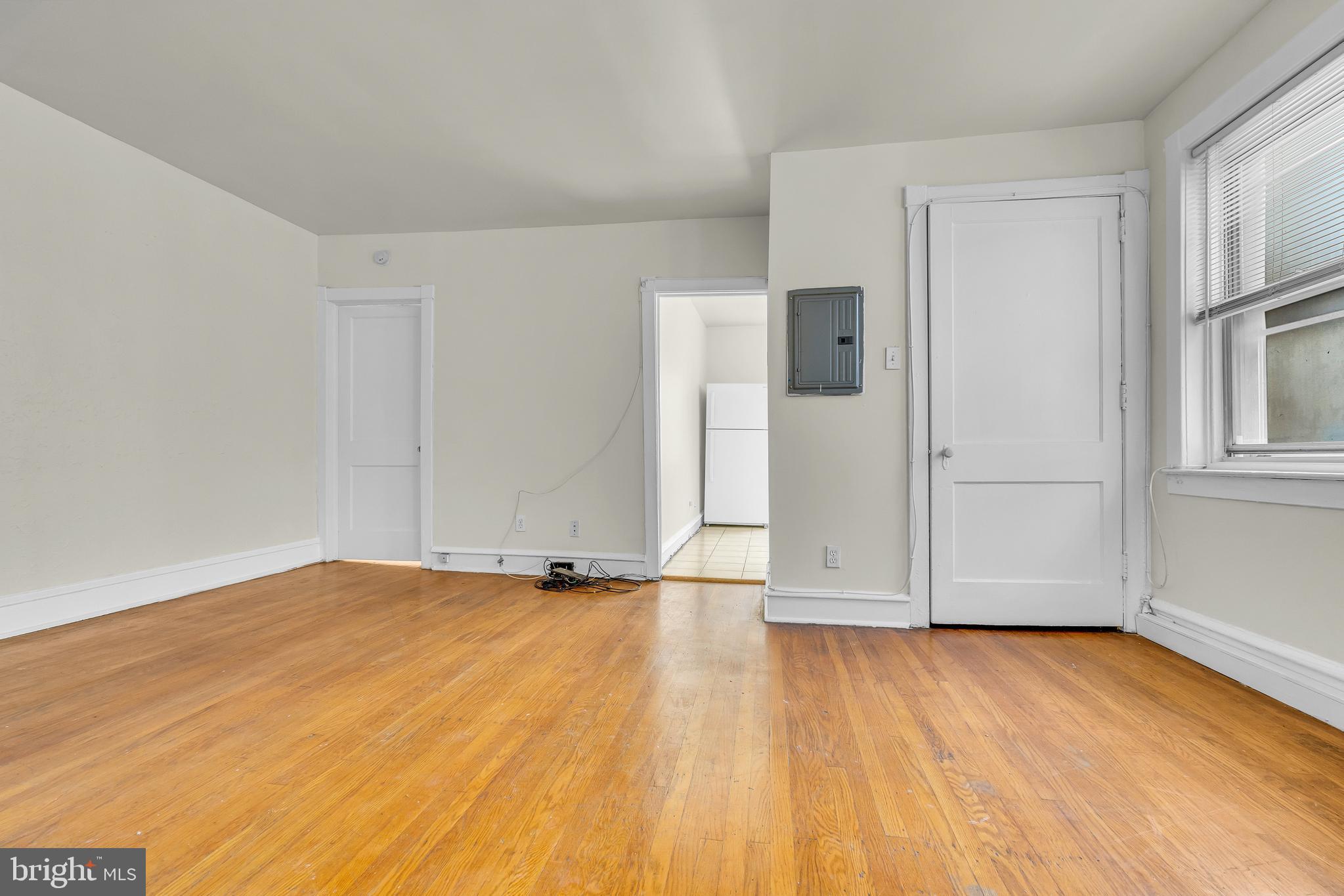 5121 East Roosevelt Boulevard, Unit 2 Philadelphia, PA 19124 - Photo 15 of 23 an empty room with wooden floor and windows