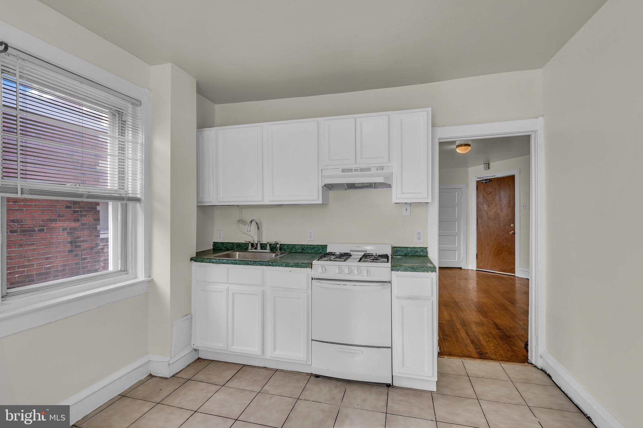 5121 East Roosevelt Boulevard, Unit 2 Philadelphia, PA 19124 - Photo 16 of 23 a kitchen with a stove a sink and a refrigerator