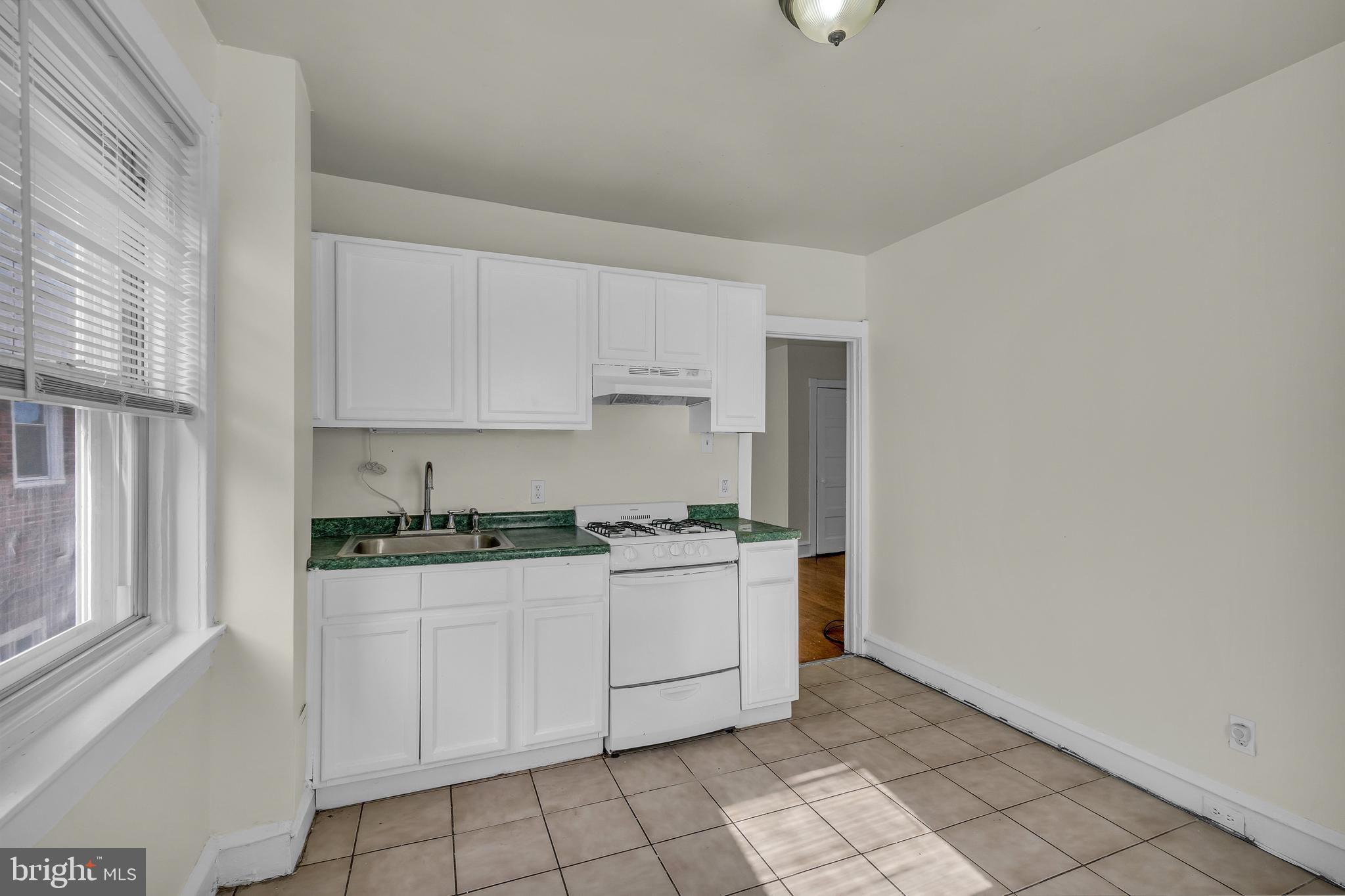 5121 East Roosevelt Boulevard, Unit 2 Philadelphia, PA 19124 - Photo 2 of 23 a kitchen with granite countertop white cabinets and white appliances