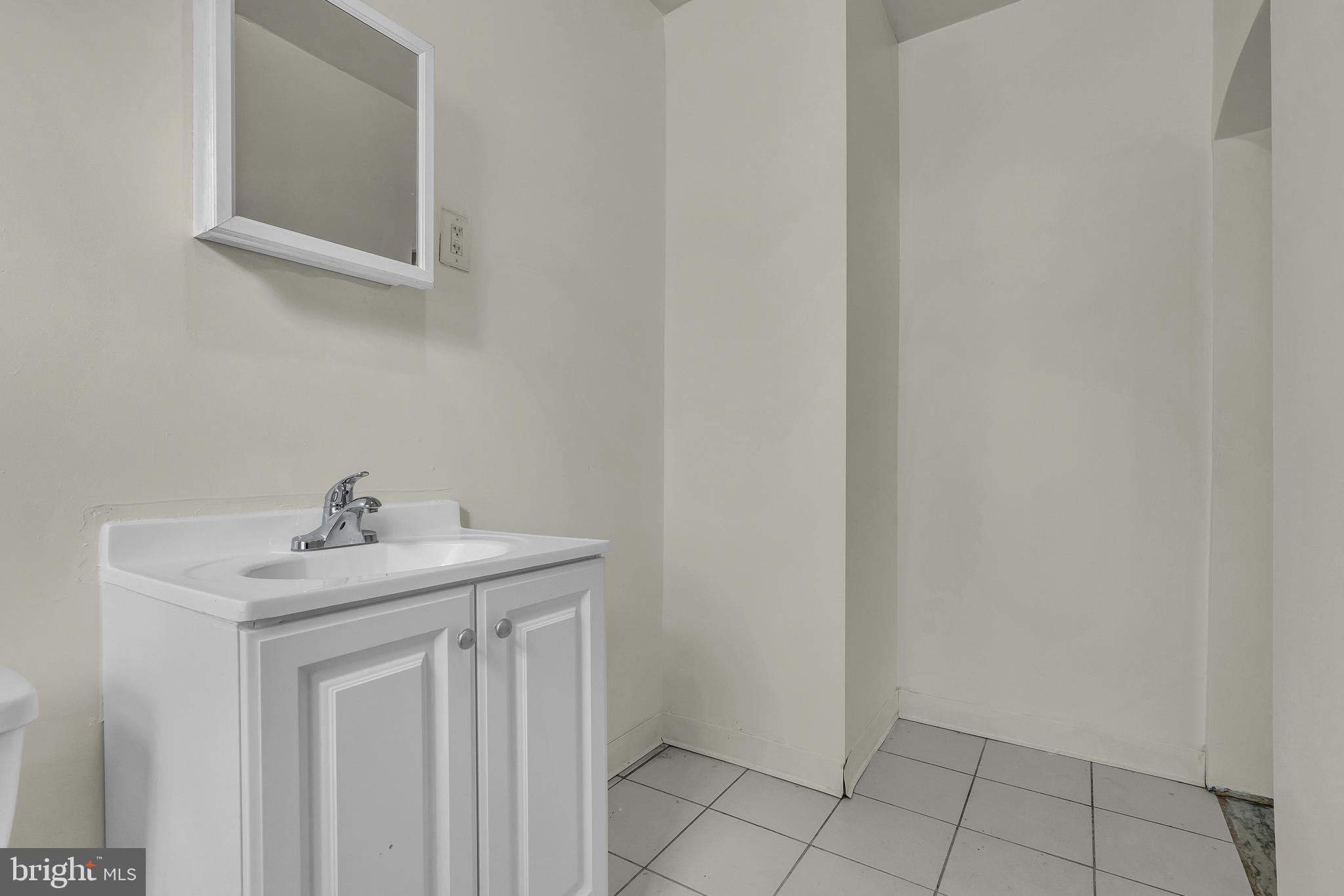 5121 East Roosevelt Boulevard, Unit 2 Philadelphia, PA 19124 - Photo 21 of 23 a bathroom with a sink and a mirror