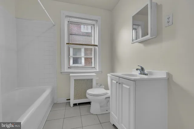 a bathroom with a sink toilet and bathtub