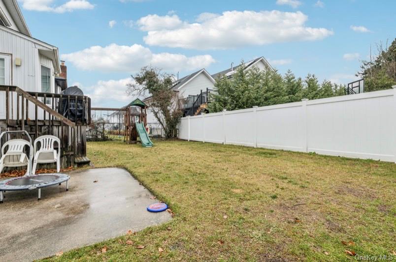 575 Rica Lane Woodmere, NY 11598 - Photo 18 of 24 Fenced backyard featuring a playground