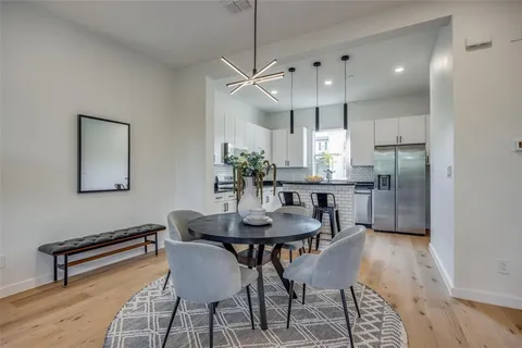 a kitchen with granite countertop white cabinets sink and stainless steel appliances