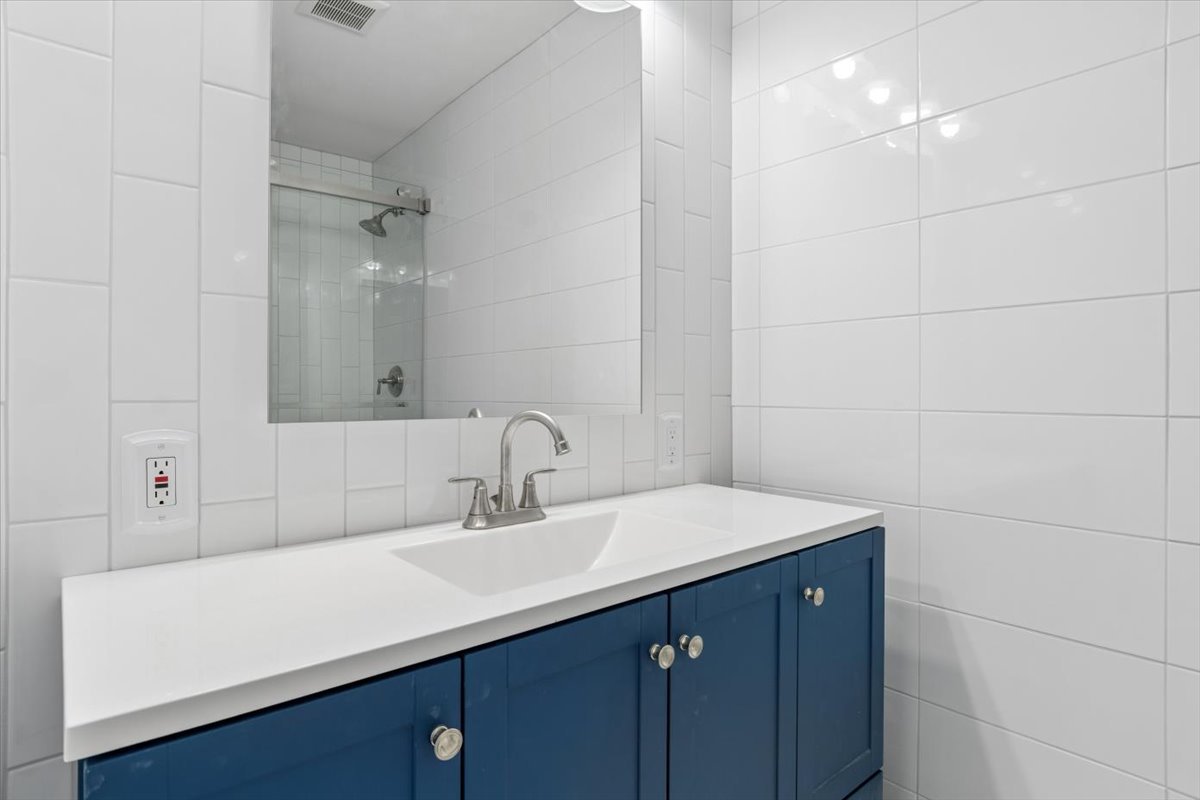 1733 Harrow Court, Unit B Wheaton, IL 60189 - Photo 11 of 23 a bathroom with a sink vanity and a mirror