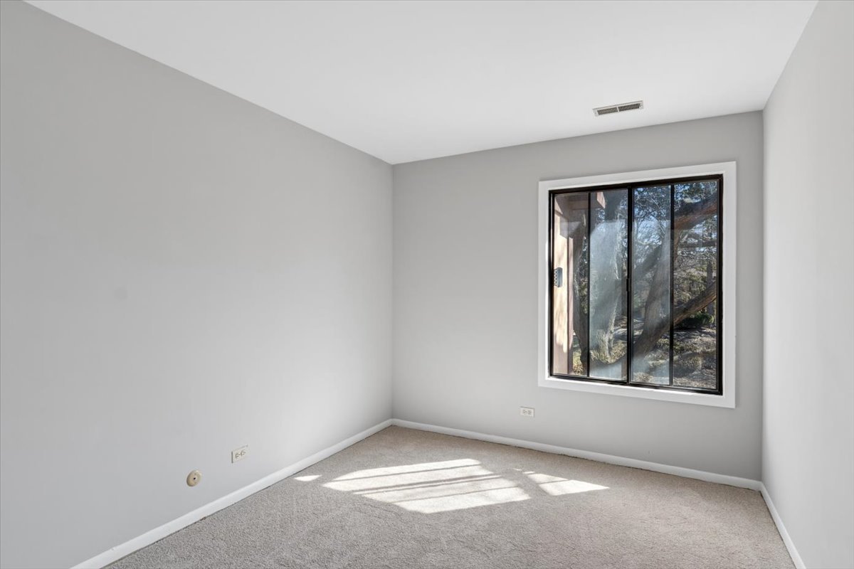 1733 Harrow Court, Unit B Wheaton, IL 60189 - Photo 13 of 23 an empty room with windows