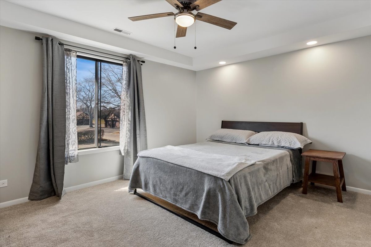 1733 Harrow Court, Unit B Wheaton, IL 60189 - Photo 18 of 23 a bedroom with a bed and window