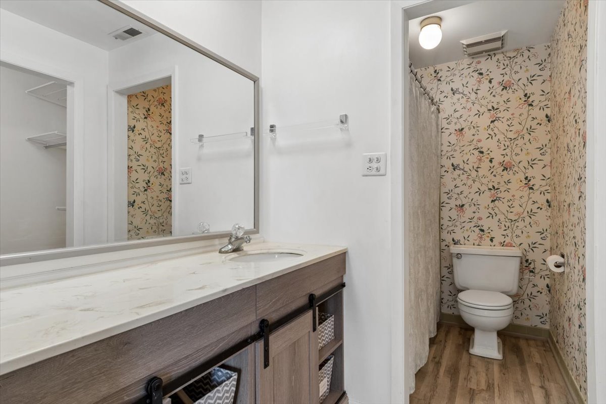 1733 Harrow Court, Unit B Wheaton, IL 60189 - Photo 19 of 23 a bathroom with a sink a toilet and shower