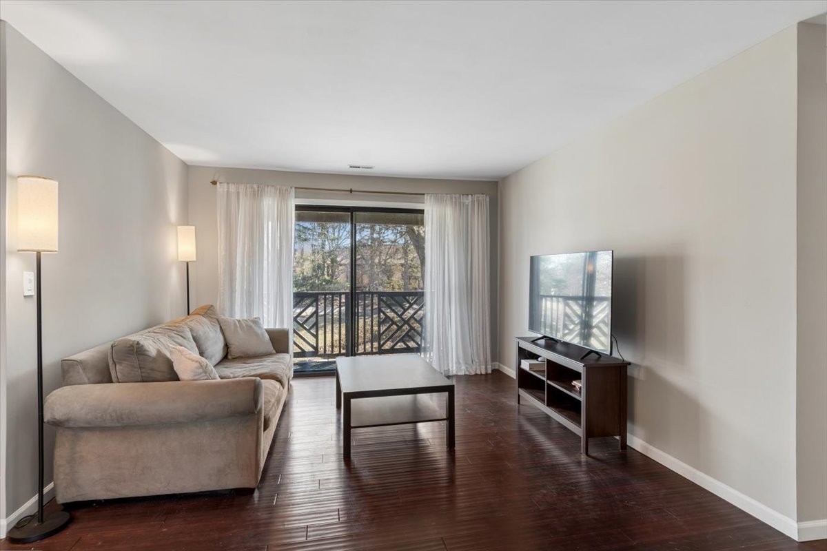 1733 Harrow Court, Unit B Wheaton, IL 60189 - Photo 2 of 23 a living room with furniture and a flat screen tv