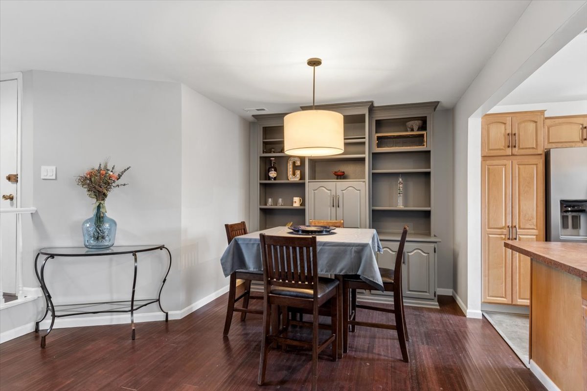 1733 Harrow Court, Unit B Wheaton, IL 60189 - Photo 4 of 23 a view of a dining room with furniture window and wooden floor