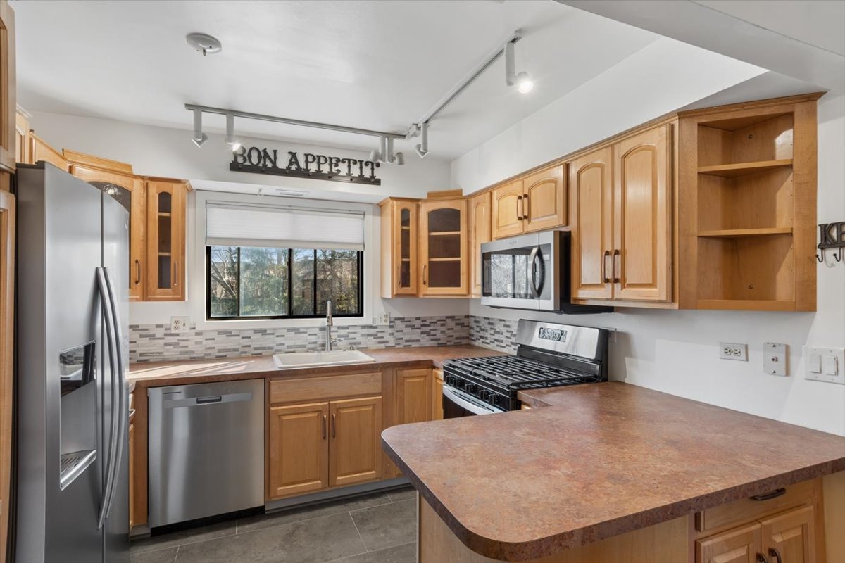 1733 Harrow Court, Unit B Wheaton, IL 60189 - Photo 6 of 23 a kitchen with stainless steel appliances granite countertop a sink refrigerator and cabinets