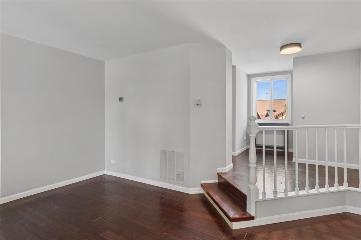 1733 Harrow Court, Unit B Wheaton, IL 60189 - Photo 7 of 23 wooden floor in an empty room with a window