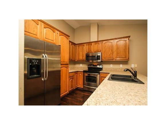 11975 Rawhide Ridge Dewey, AZ 86327 - Photo 4 of 14 a kitchen with stainless steel appliances kitchen island granite countertop a refrigerator stove and sink