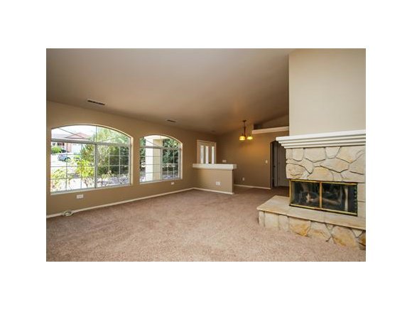 11975 Rawhide Ridge Dewey, AZ 86327 - Photo 7 of 14 a living room with a fireplace furniture and a large window