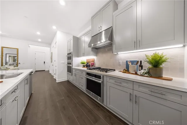 a kitchen with granite countertop chairs and white appliances