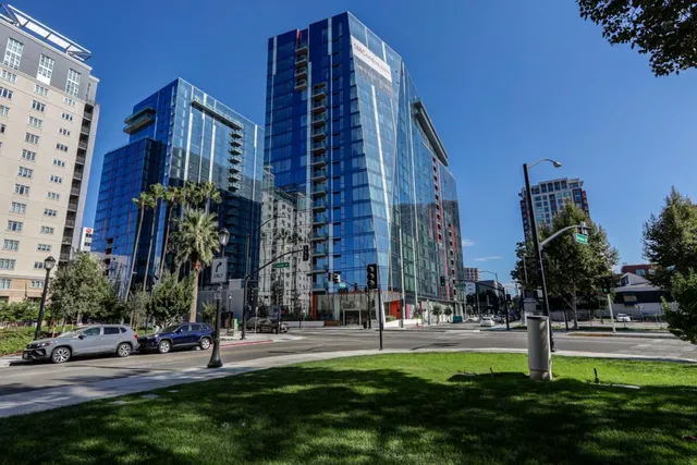 a view of a tall building with a yard