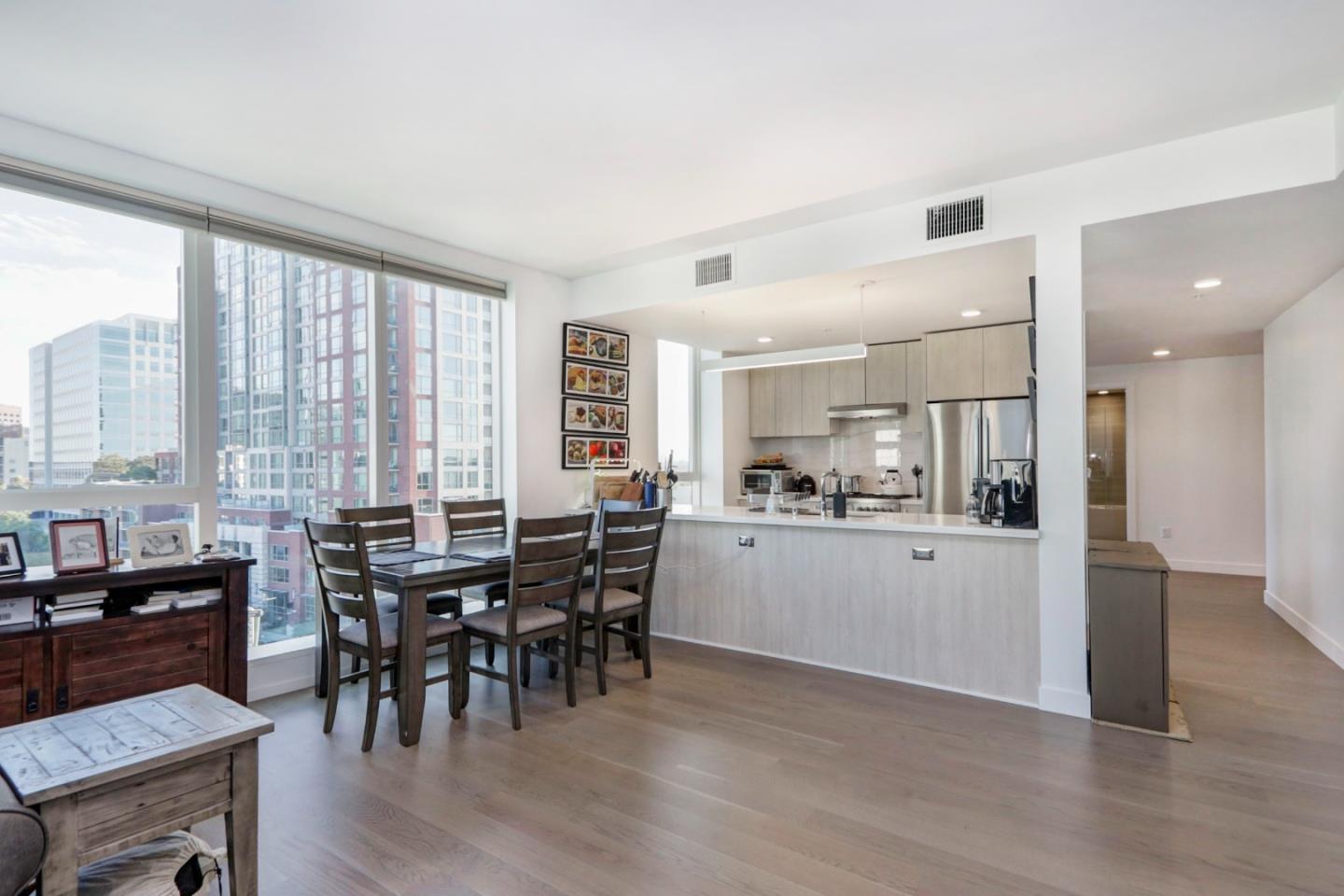 188 West St James Street, Unit 10819 San Jose, CA 95110 - Photo 12 of 41 a kitchen with stainless steel appliances kitchen island granite countertop a table chairs sink and cabinets