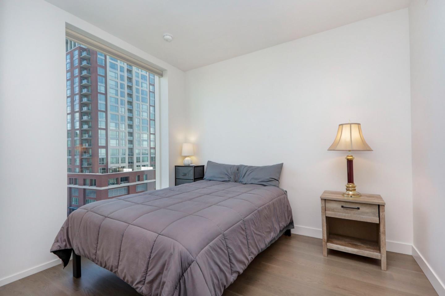 188 West St James Street, Unit 10819 San Jose, CA 95110 - Photo 15 of 41 a bedroom with a bed and a lamp