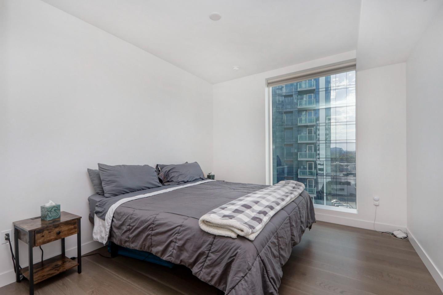 188 West St James Street, Unit 10819 San Jose, CA 95110 - Photo 17 of 41 a bedroom with a bed and a window