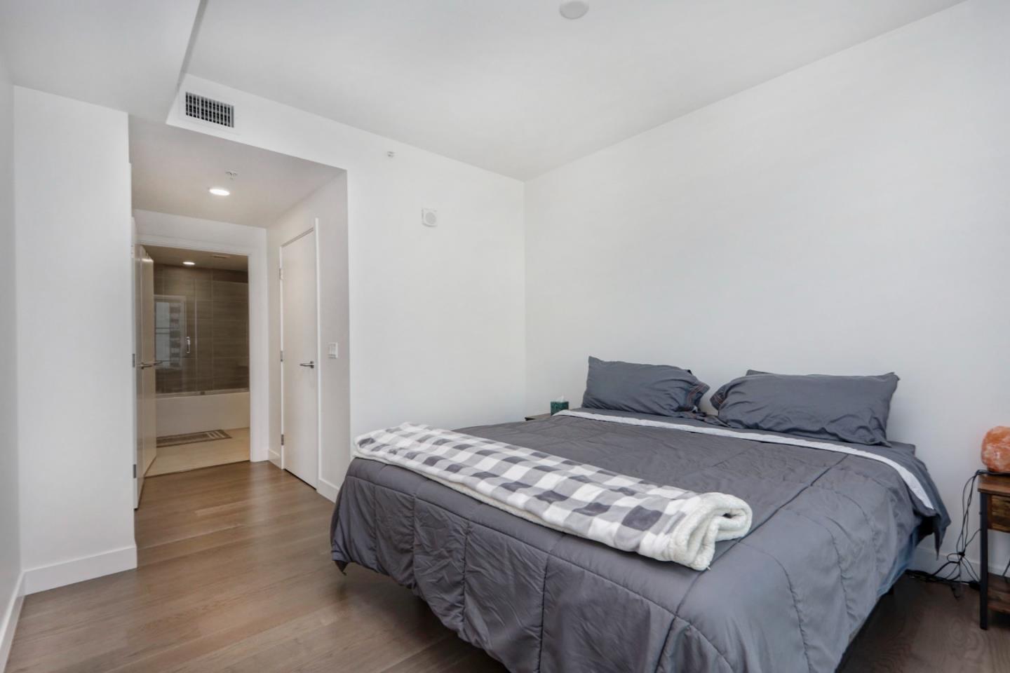 188 West St James Street, Unit 10819 San Jose, CA 95110 - Photo 18 of 41 a bedroom with a bed and a view of bathroom