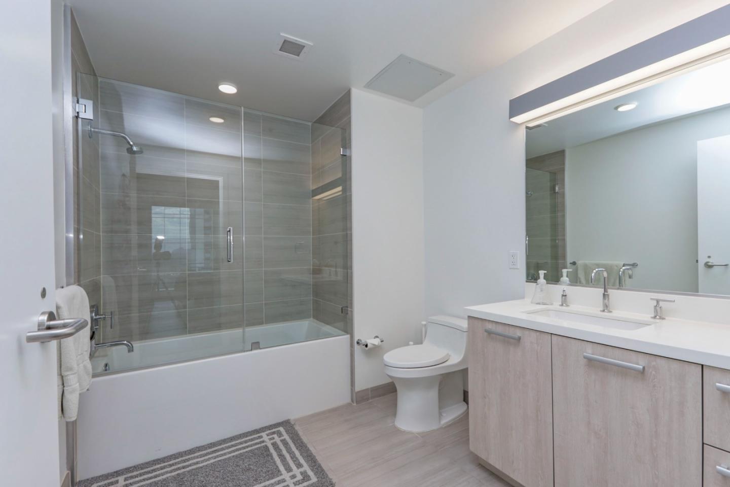 188 West St James Street, Unit 10819 San Jose, CA 95110 - Photo 19 of 41 a bathroom with a bathtub shower sink mirror and toilet