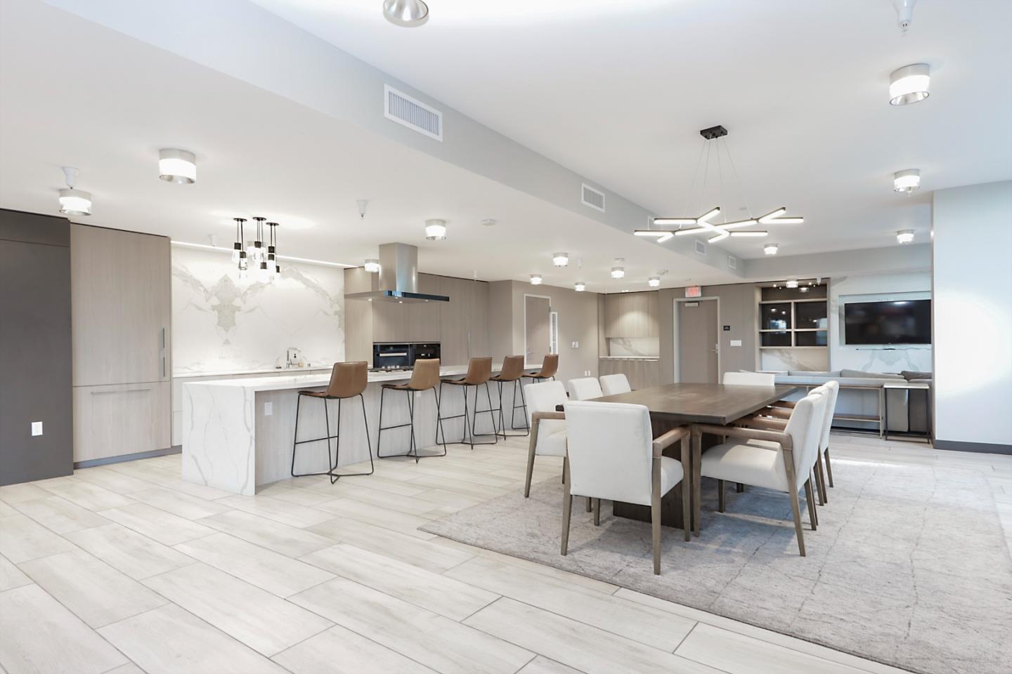188 West St James Street, Unit 10819 San Jose, CA 95110 - Photo 25 of 41 a dining hall with stainless steel appliances kitchen island granite countertop a table and chairs in it