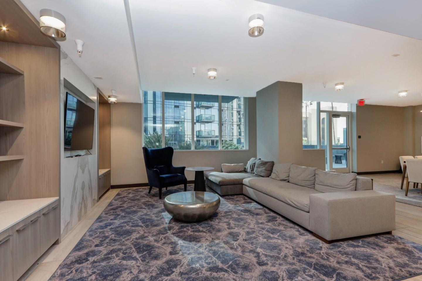 188 West St James Street, Unit 10819 San Jose, CA 95110 - Photo 29 of 41 a living room with furniture a large window and a rug
