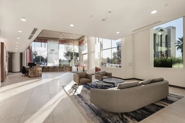 a living room with furniture and a floor to ceiling window
