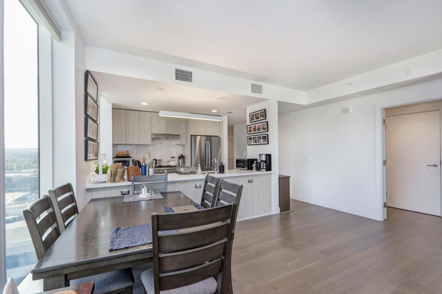 188 West St James Street, Unit 10819 San Jose, CA 95110 - Photo 8 of 41 a view of a dining room with furniture and wooden floor