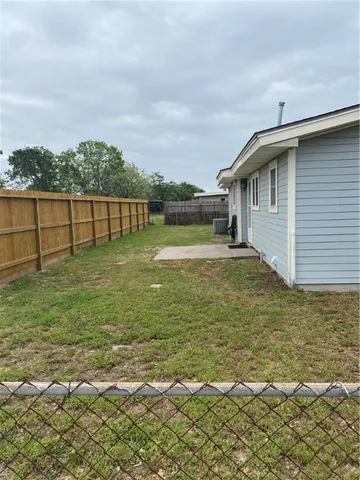 a view of a patio with a yard