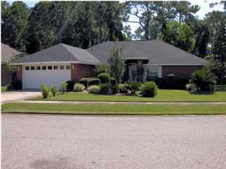 3892 Mesa Road Destin, FL 32541 - Photo 1 of 12 a front view of a house with a garden