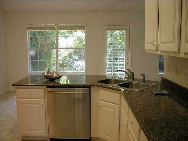 3892 Mesa Road Destin, FL 32541 - Photo 11 of 12 a kitchen with stainless steel appliances granite countertop a sink stove and cabinets