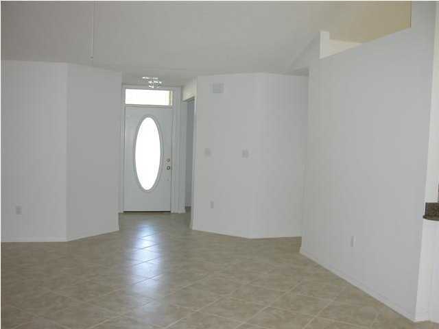 3892 Mesa Road Destin, FL 32541 - Photo 12 of 12 an empty room with wooden floor and white walls