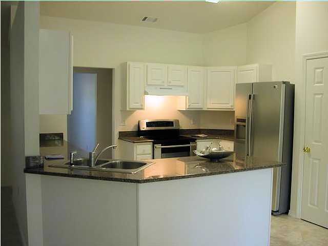 3892 Mesa Road Destin, FL 32541 - Photo 4 of 12 a kitchen with granite countertop a refrigerator and a sink