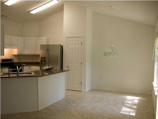 3892 Mesa Road Destin, FL 32541 - Photo 5 of 12 a kitchen with stainless steel appliances a refrigerator and a stove