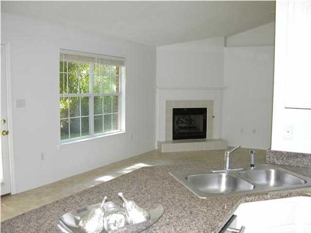 3892 Mesa Road Destin, FL 32541 - Photo 7 of 12 a kitchen with granite countertop a stove a sink and a counter space