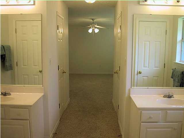 3892 Mesa Road Destin, FL 32541 - Photo 10 of 12 a bathroom with a sink a mirror and a shower
