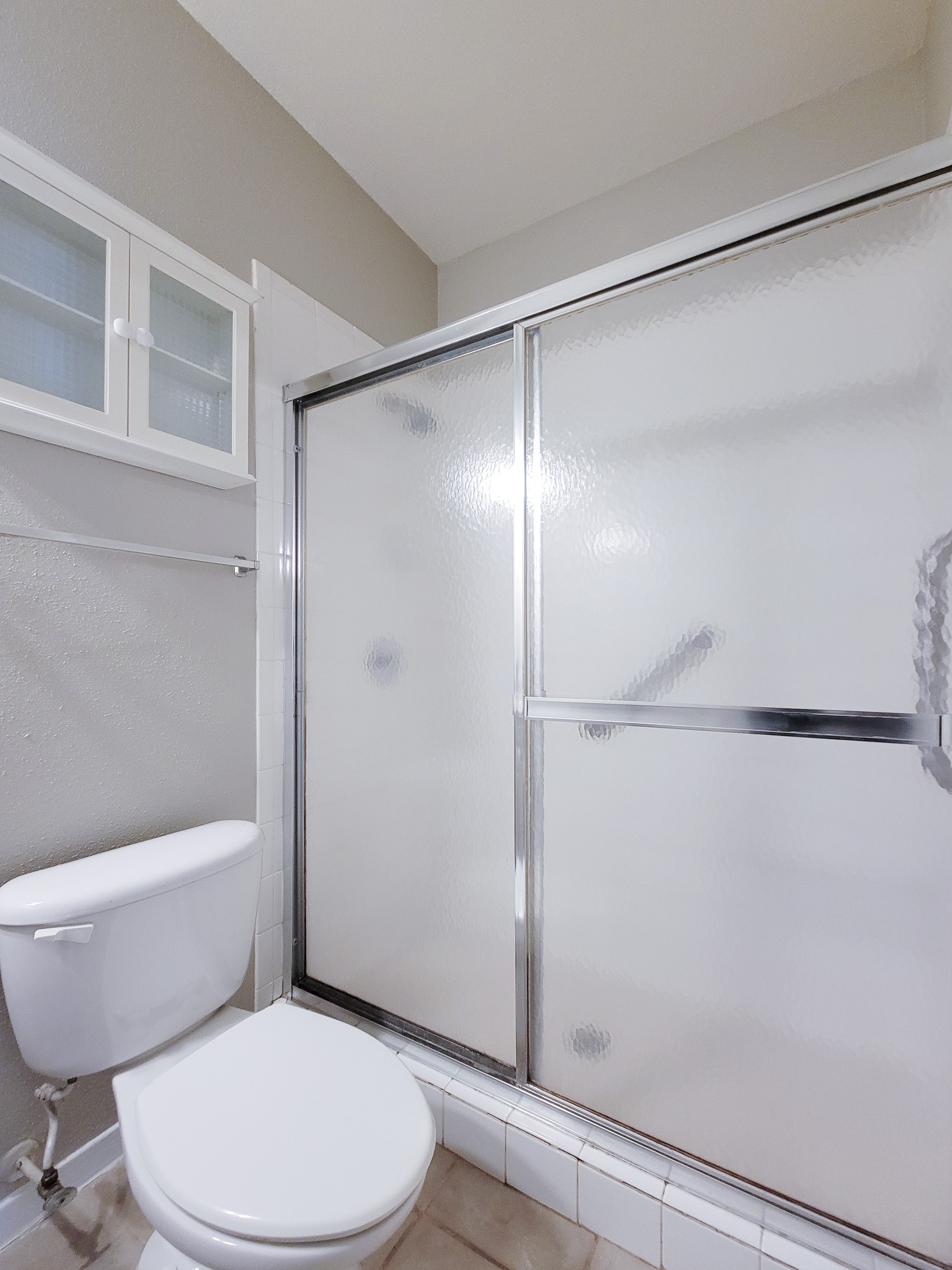 4041 Drake Street, Unit 116 Houston, TX 77005 - Photo 22 of 27 a white toilet sitting next to a bathroom sink