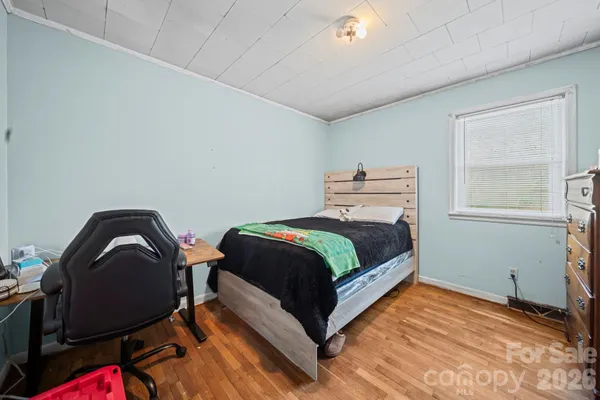 a bedroom with a bed chair and window