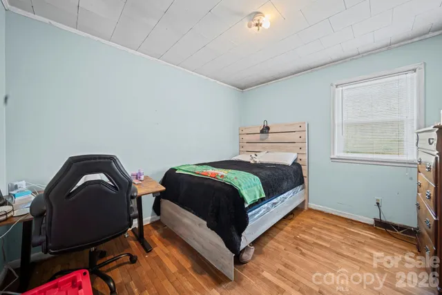 a bedroom with a bed chair and window