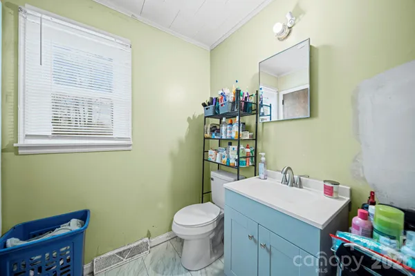 a bathroom with a sink mirror and toilet