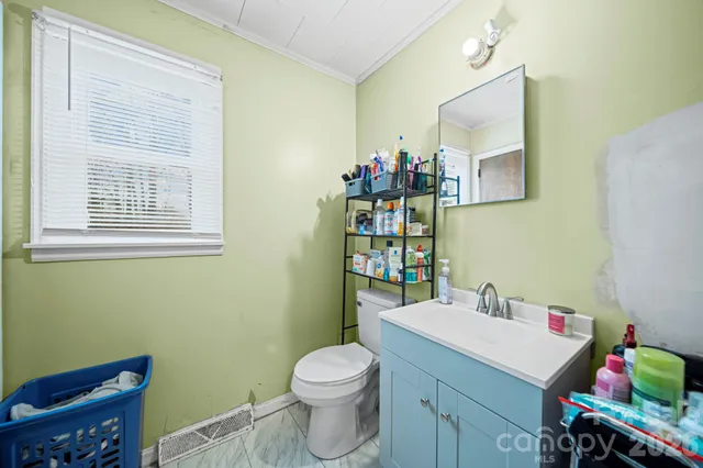 a bathroom with a sink mirror and toilet