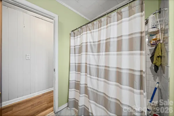 a bathroom with a shower curtain and a curtain