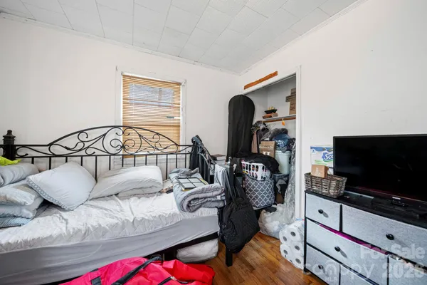 a bedroom with furniture and a flat screen tv