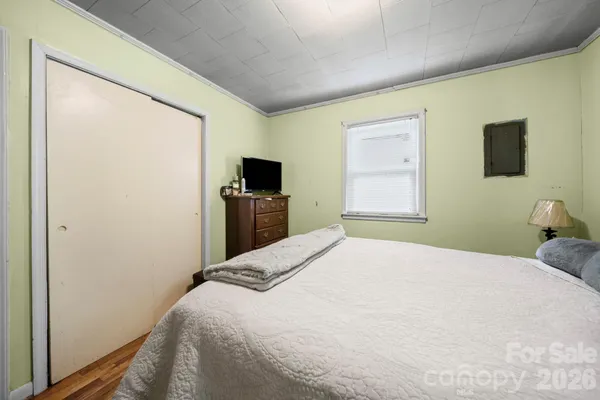 a bedroom with a bed and a flat screen tv