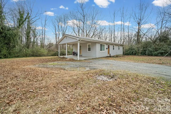 a front view of house with yard and trees