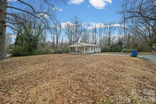 a view of a white house with a yard