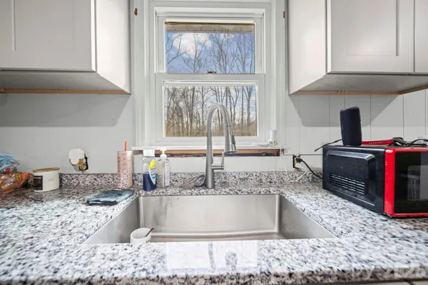 a kitchen with a stove a sink and a cabinets